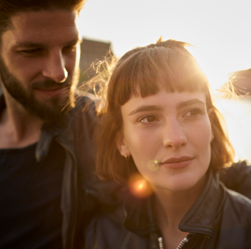 Man with his arm around a woman's shoulder